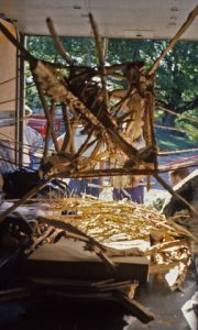 geometrically symmetrical, four-sided wooden stucture hanging inside a truck